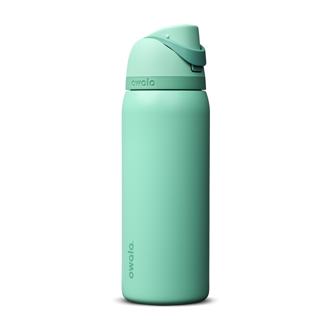 Owala FreeSip 32oz in 90s Kid, bright mint teal insulated bottle with matching teal flip cap and carry loop